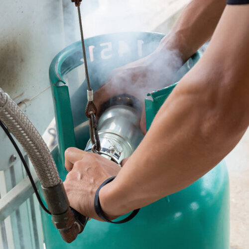 A man working with a gas tank